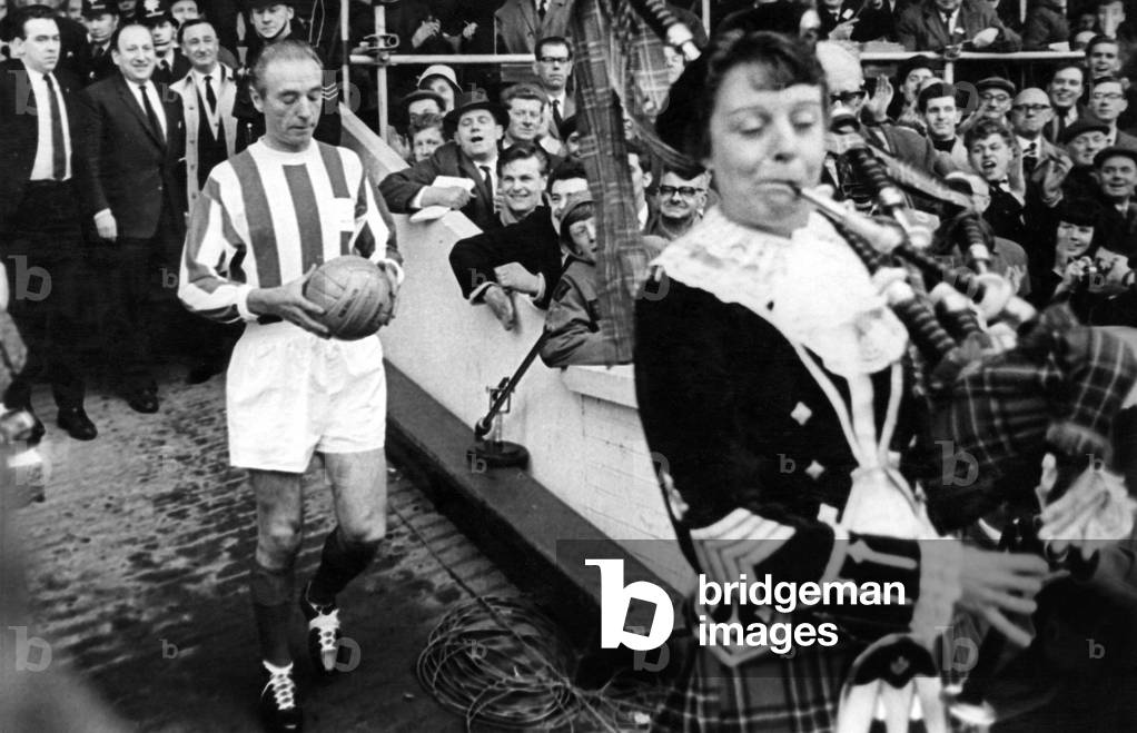 Sir Stanley being piped onto the field. April 1965 (photo)