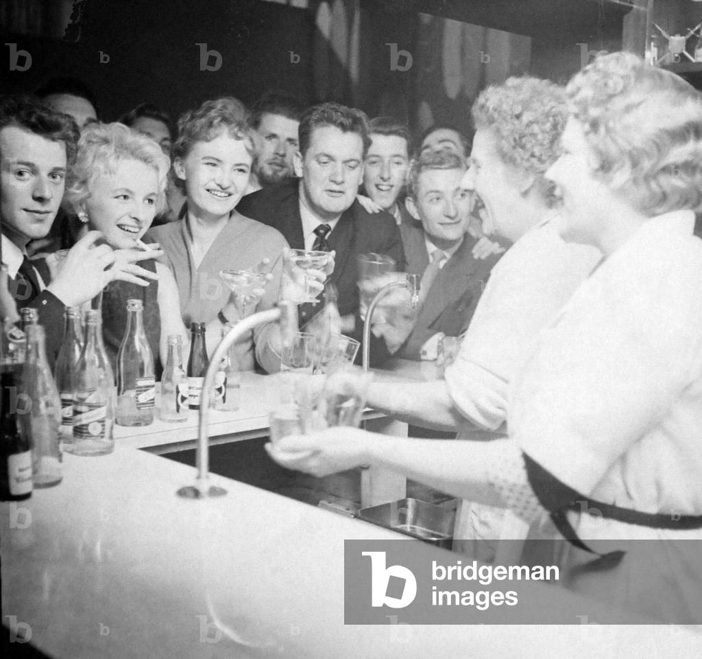 Jazz reacts differently on different people. But members of Studio One are almost unanimous on one thing: it makes you thirsty. So the bar at the club has a busy time, September 1958 (b/w photo)