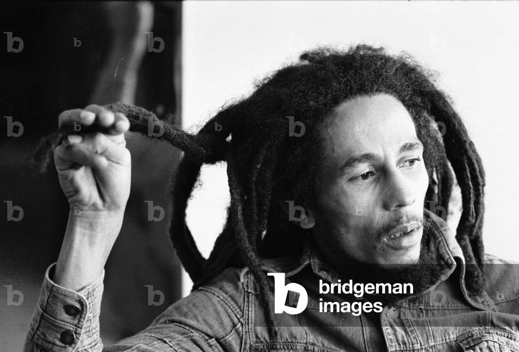 Bob Marley Jamaican Reggae singer writer talking during an interview for the Daily Mirror, playing with his dreadlocks, 22 June 1978 (b/w photo)