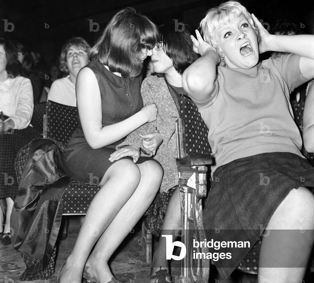 Screaming girl fans greet The Beatles on their appearance at the ABC Cinema in Wigan, 13th October 1964 (b/w photo)