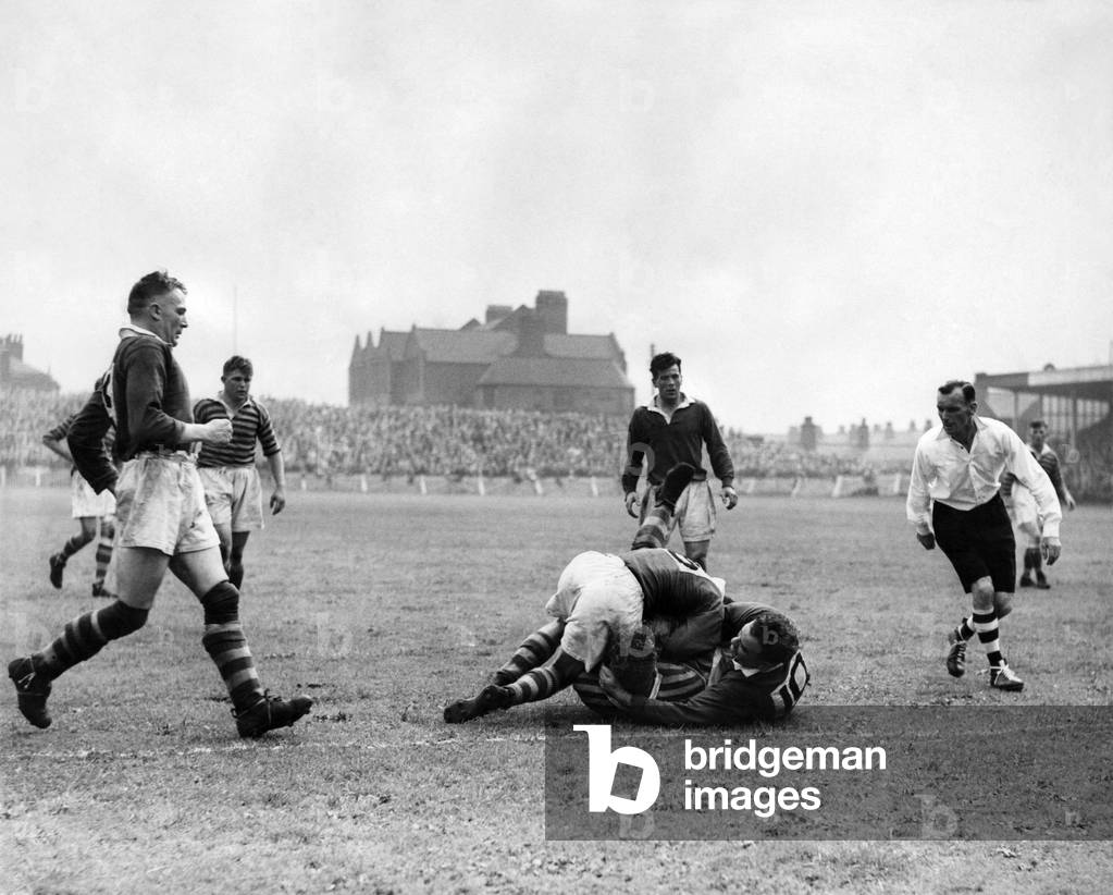Salford v Warrington. Davies, the salford half-back, and Hawkins, Salford forward, combine in grounding Derbyshire, the Warrington forward, inches from the line Running in from left is Curran, the Salford hooker, to make sure there is no slip up. August 1949