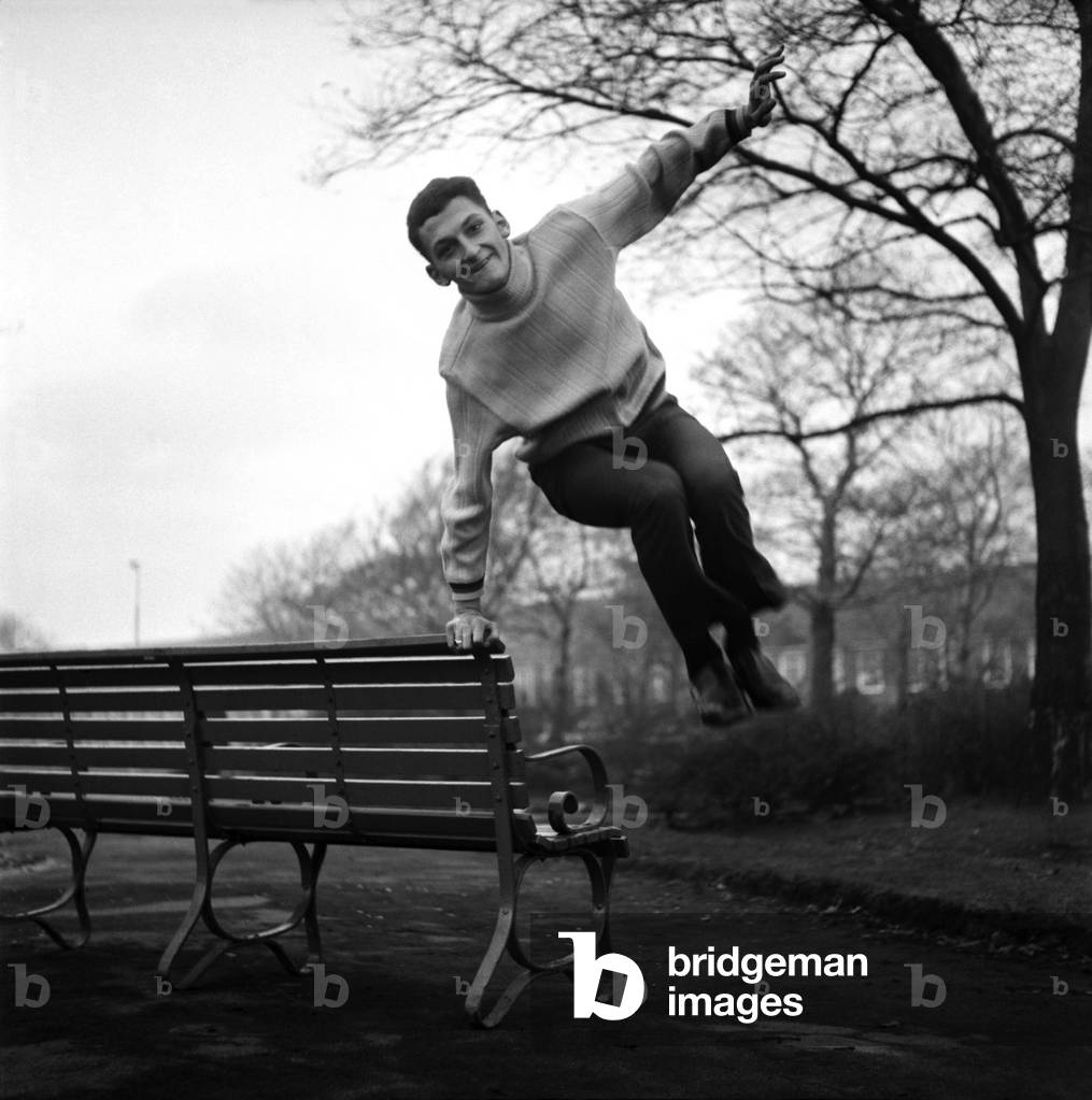 Sport. Football. Liverpool player Steve Peplow leaps in the air by a bench in the park. November 1969 (photo)