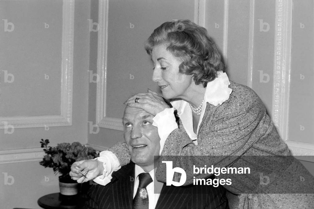 Dame Vera takes the temperature of her patient Henry Cooper, January 1976 (b/w photo)