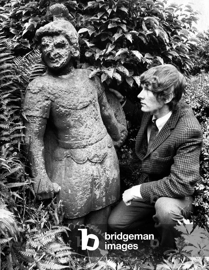 A piece of Alnwicks history went under the auctioneers hammer in September 1971. In this picture from our archives, auctioneers clerk Mark Marshall examines the stone statue of a soldier believed to have stood guard at Alnwick Castle for 1,000 years. The 5ft statue of a soldier wearing a plumed helmet and carrying a shield used to stand on the castle ramparts, until it was removed during alterations and taken to the front garden of Ravensmount, a house in Alnwick whose contents were being auctioned. Mark said: Its not very often you get something like this to auction. Its the sort of thing that would go nicely in a country garden, but not my flat in Jesmond. 31st August 1971 (b/w photo)