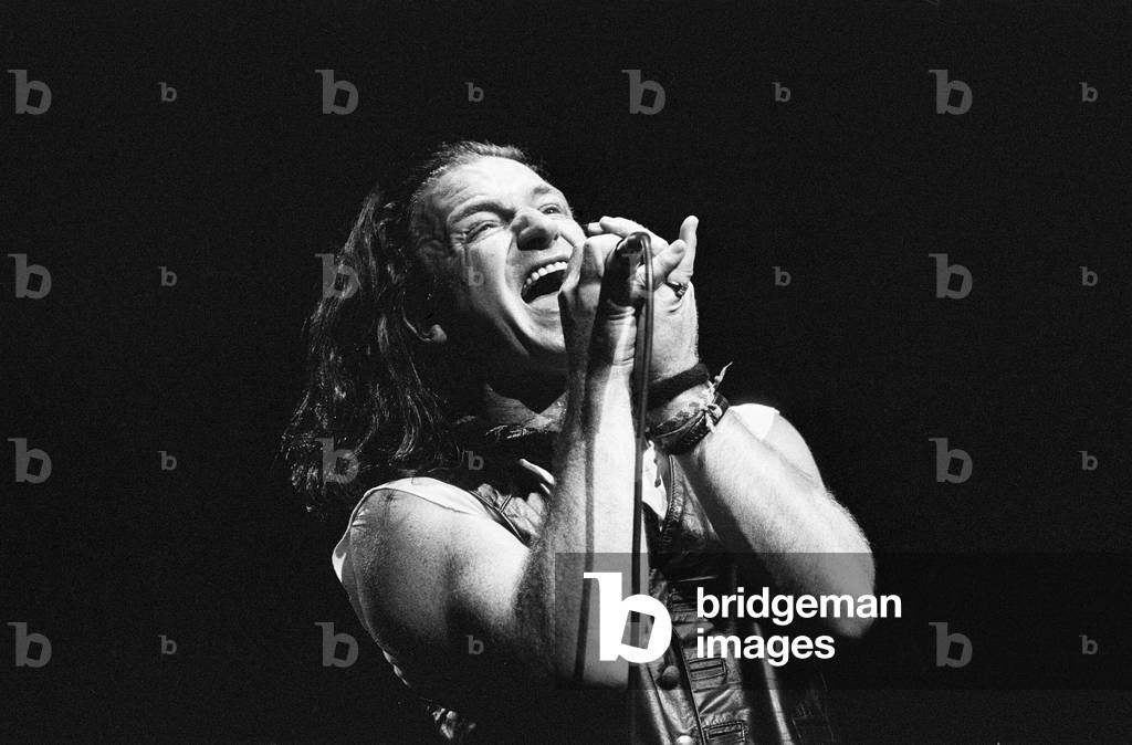 Rock group U2 performing on stage at the National Exhibition Centre in Birmingham. Pictured is lead singer Bono. 3rd August 1987 (b/w photo)