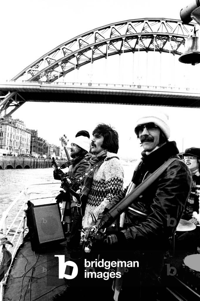 Lindisfarne sailed down the Tyne on a musical journey. The group were filming on board a Tyne ferry for a half-hour television show called 'All Right Now'. Si Cowe, Ray Jackson and Alan Hull pictured. 4th March, 1979 (b/w photo)