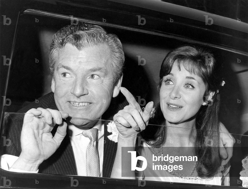 Actor Kenneth More, 53, and his bride, 27 year old actress Angela Douglas who is his third wife in 1968 (b/w photo)