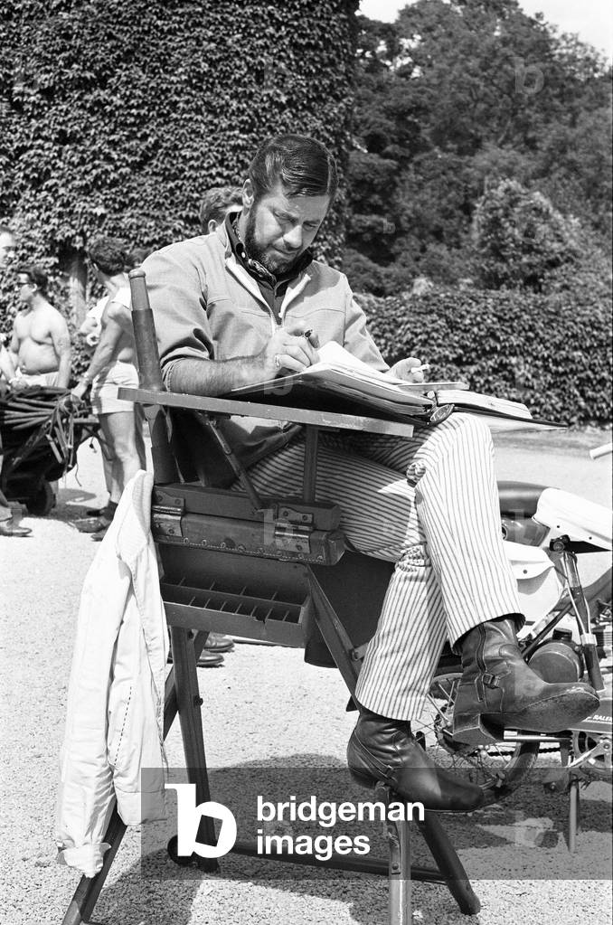 Director Jerry Lewis seen here reading the script whilst on location at Eastnor Castle, Ledbury whilst filming 