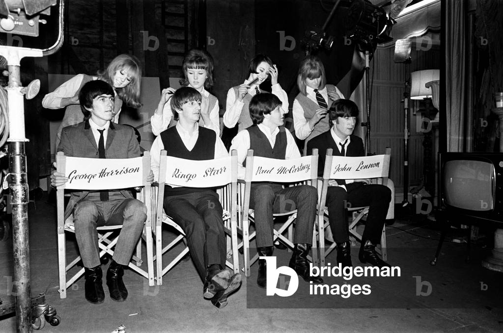 The Beatles pose for pictures during filming of A Hard Day's Night at Madame Tussauds in London, 12th March 1964.