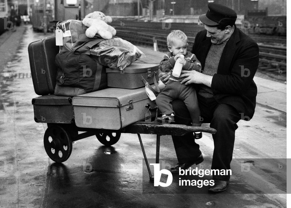 Porter Wally Lawes of Euston Station London was left holding the baby, 1 year old Deidre, after her parents Mr and Mrs O Hara departed for Manchester on the train. Mr O'Hara had left his wife and daughter to get tickets, he was delayed so Mrs O'Hara went to look for him. As the train began to leave, the Porter found the baby alone and grabbed her and the luggage off the train. At the same time the parents jumped back on the train and left the station. They pulled the emergency cord and when the train stopped they walked back to Euston - luckily as the next stop was 177 miles away! Wally looked after Deidre until they returned. 20th January 1967