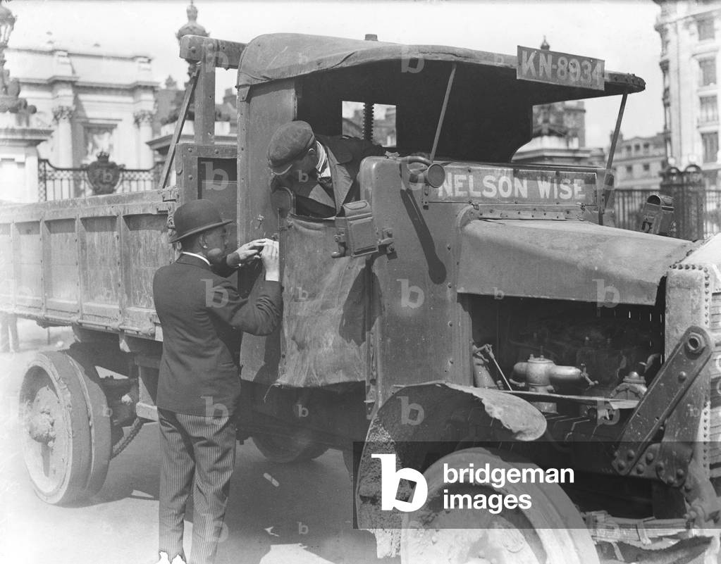 Food transport driver seen here getting his instructions at the Hyde Park transport depot on the second day of the General Strike. The national dispute came about after negotiations between the miners and mine owners failed and the strike began on 3 May 1926. Millions obeyed the strike call, bringing transport systems to a halt while newspapers were not printed. The government responding by using volunteers to run trains and buses and sent in troops to move supplies from the London docks. There were clashes between police and crowds in many areas and at least 4000 strikers were arrested. There were attacks on buses and trains, including the derailing of the Flying Scotsman. The strike was called off unilaterally by the TUC on 12 May with no guarantees of fair treatment for the miners who fought on to bitter defeat in October, 4th May 1926 (b/w photo)