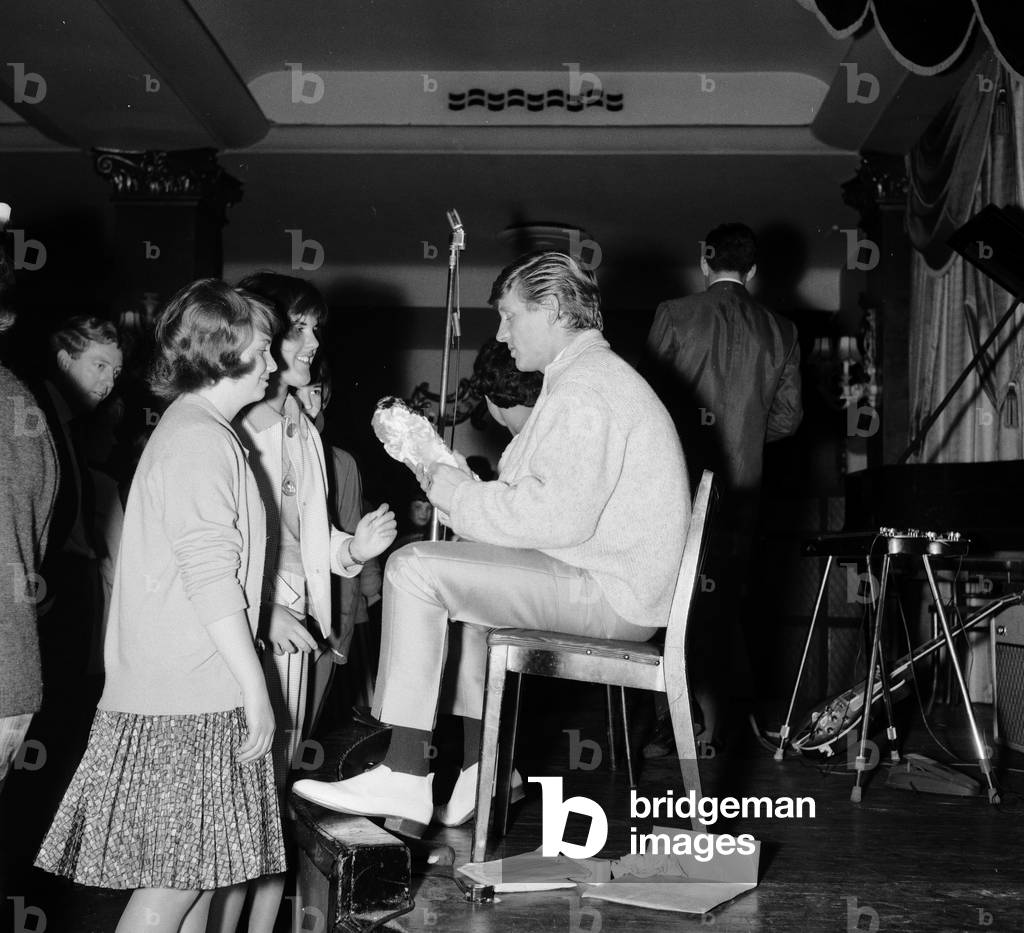 Fans welcome the return of pop singer Johnny Leyton at a fan club concert at the Empire Rooms in London. 1st October 1962 (b/w photo)