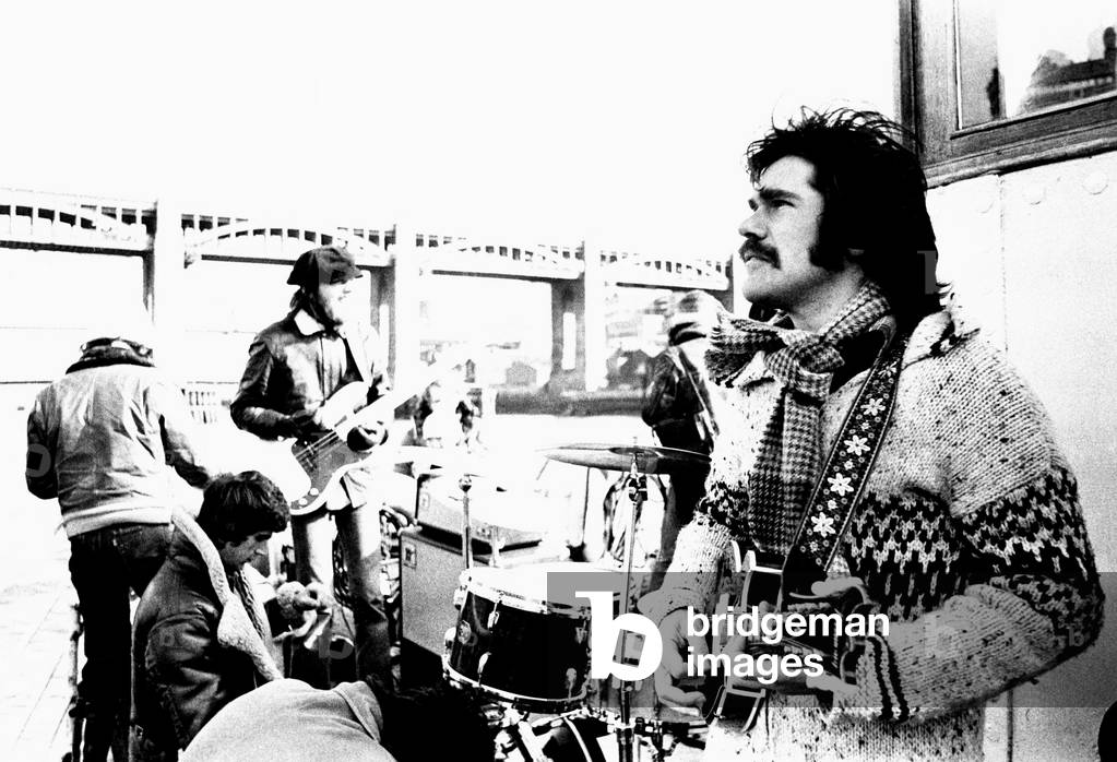 Lindisfarne sailed down the Tyne on a musical journey. The group were filming on board a Tyne ferry for a half-hour television show called 'All Right Now'. 4th March, 1979 (b/w photo)