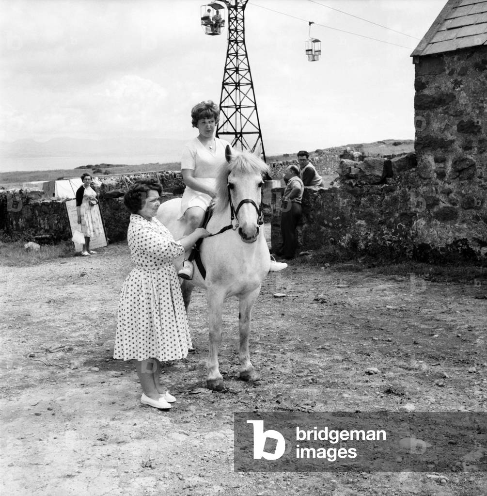 Butlins Holiday Pwllheli. Mrs Nellie McGrail. Pools Winner. Horse riding/ Boating/elephant Rollerskating/family. Mrs. Nellie McGrail the £250,000 pools winner enjoys an Ice Cream cornet on holiday