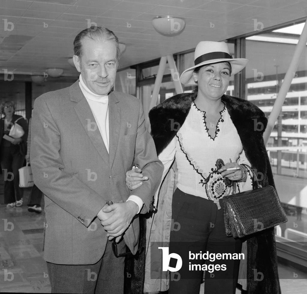 Scottish thriller writer Alistair MacLean with his wife Mary Marcelle Maclean leave London airport for Los Angeles for preliminary discussions regarding a new book and screenplay, 29th September 1973 (b/w photo)