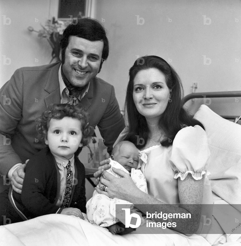 Proud father Terry Wogan allowed news crews to document his visit to Queen Charlotte's Hospital as he brought his eldest son Alan Wogan, 2½, to visit his mother Helen Wogan and new born baby brother aged just two days old, 15th April 1970 (b/w photo)