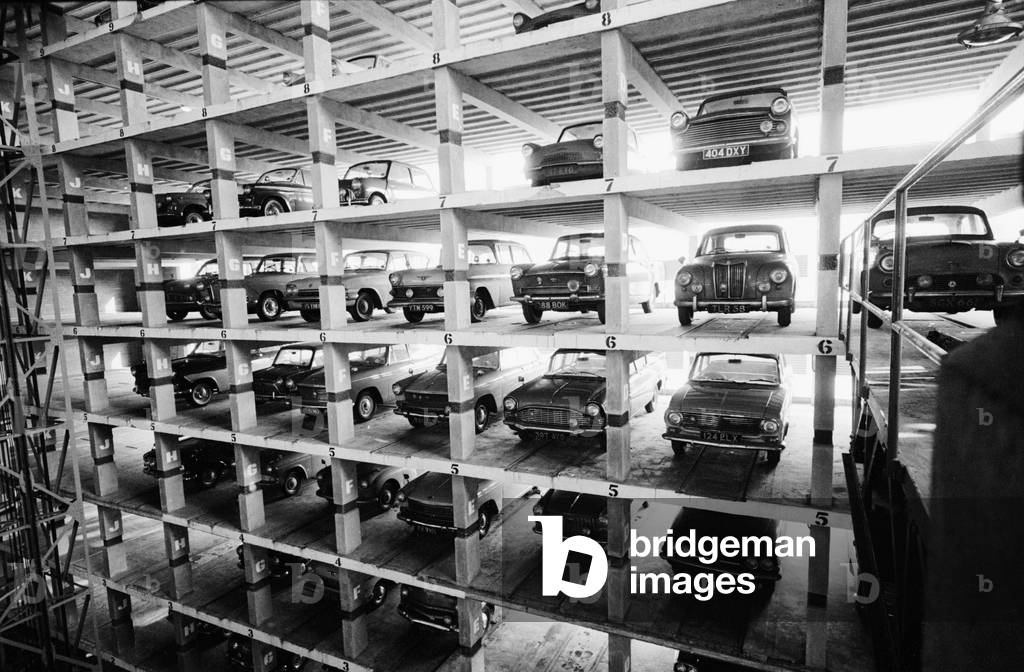 An eleven storey mechanical car park in operation in Shoe Lane, London which holds 279 cars. They are driven into one of ten bays are parked automatically by means of two lifts.
18th January 1963.