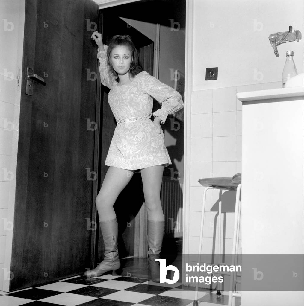 Former art student Julia Canning, aged 20 of Seaford, Sussex, is now a successful model. Posing wearing a mini dress and knee high boots. 
December 1969
