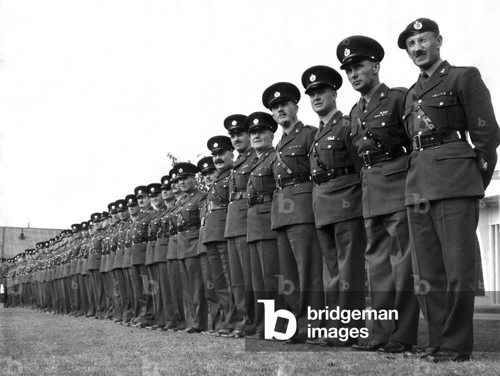 Army: Line up of fifty three Regimental Sergeant Majors. October 1964 (b/w photo)