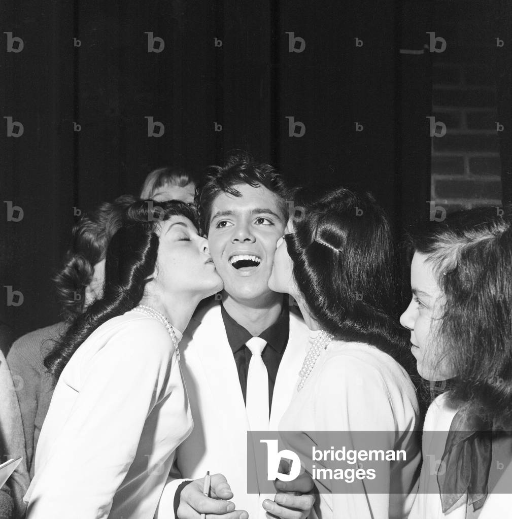 A kiss for Cliff Richard from twin fans at Rochester, New York, USA, during his coast to coast USA tour. January 1960.
