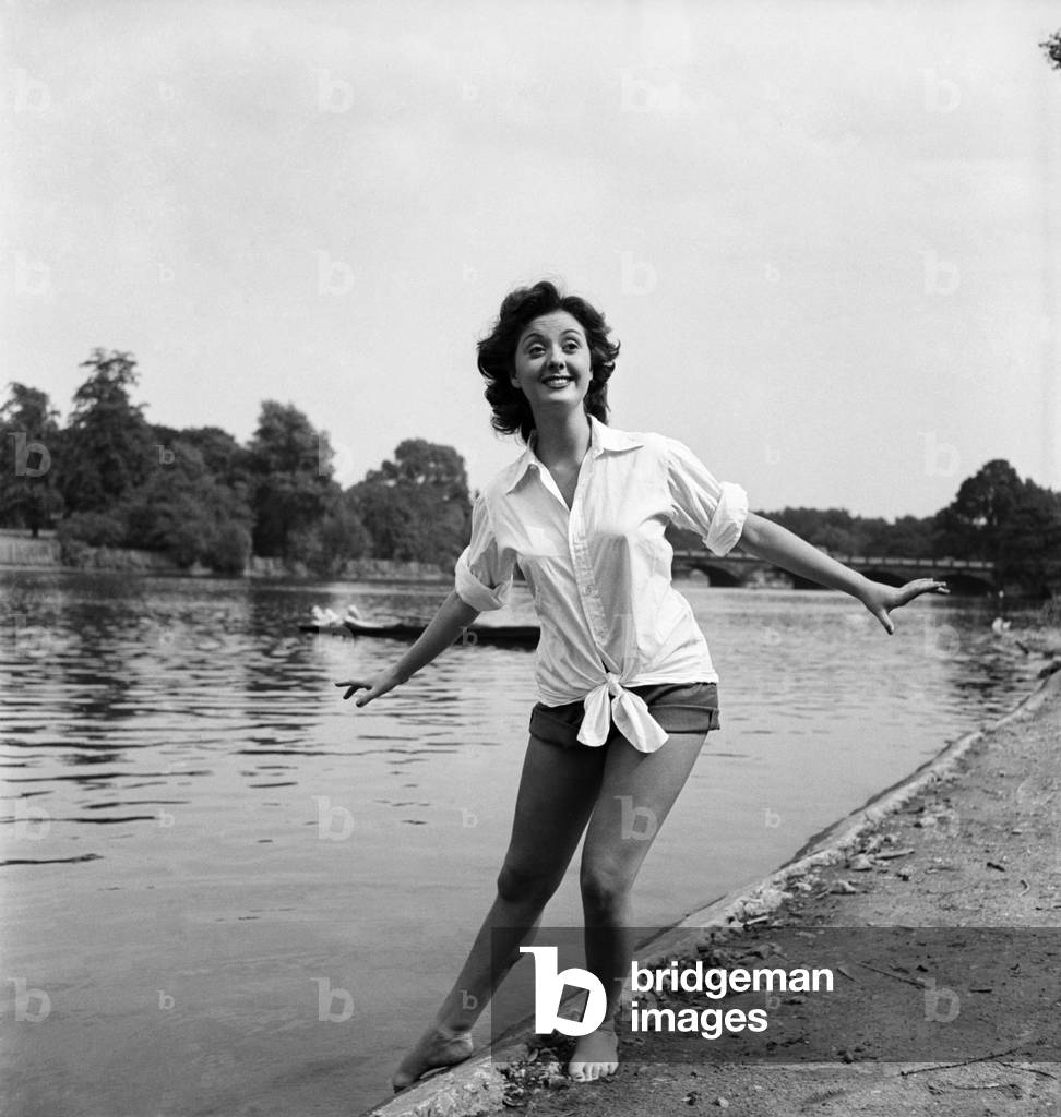 Actress Lana Morris wears a shirt over her shorts. August 1949 O20168-002