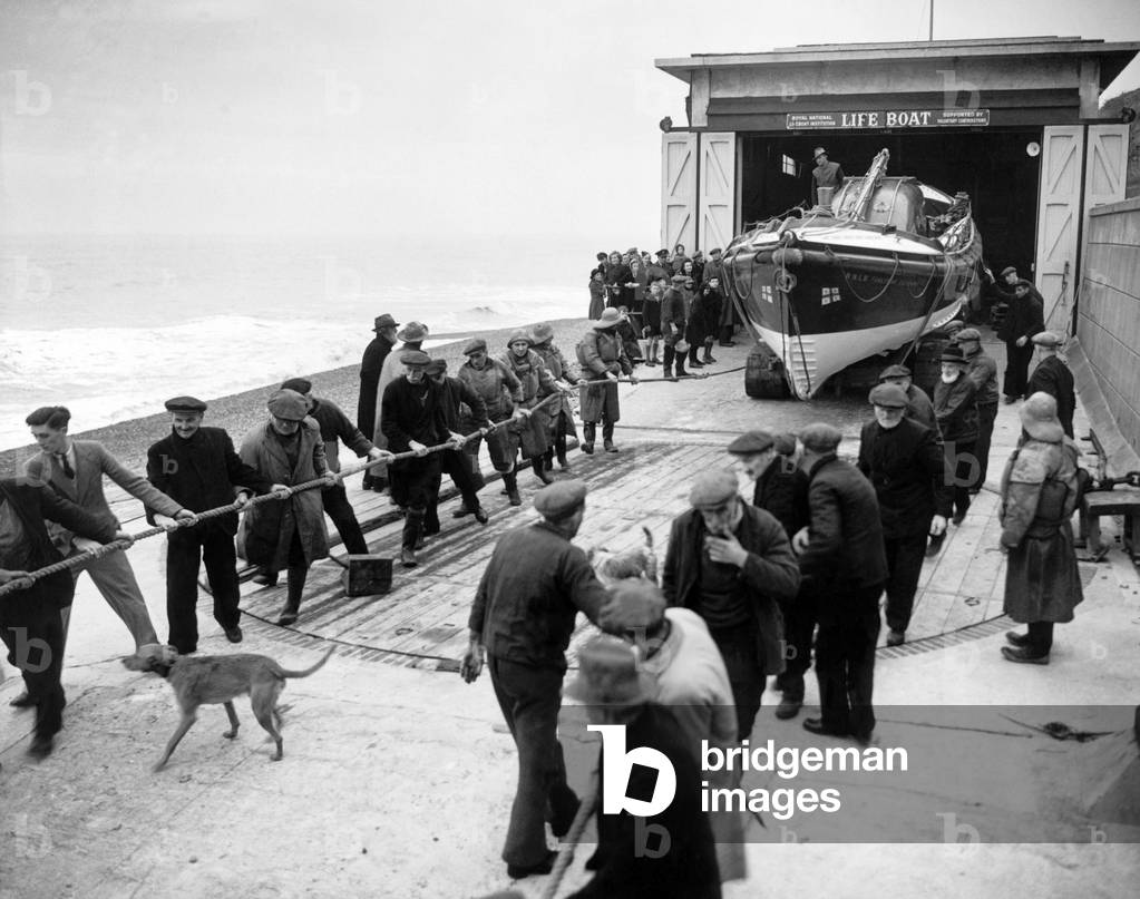 Lifeboatmen of Sheringham, Norfolk stand by during operational flights over the North Sea to rescue airmen who may have dropped into the sea on their way out to or returning from missions abroad, 12th January 1944 (b/w photo)