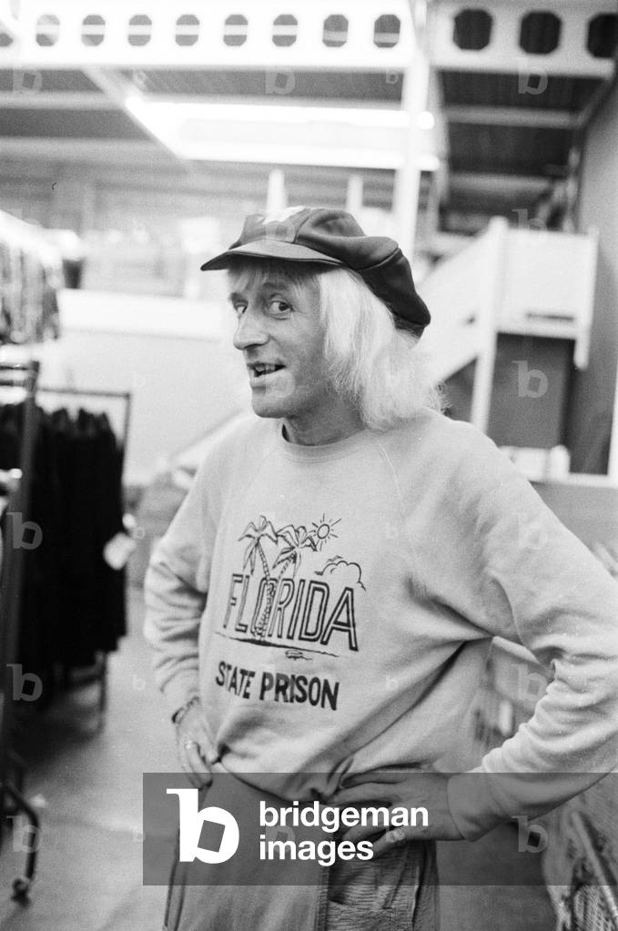 A day in the life of Jimmy Saville' Feature by Mike Hellicar. Here he is pictured trying on an outfit at Lord John warehouse in Acton, 7th October 1971 (b/w photo)