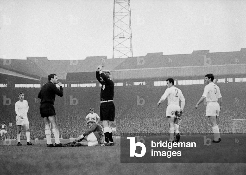 Manchester United's Denis Law lies injured on the ground against Real Madrid in the European Cup Semi Final match at Old Trafford. United won the game 1-0. April 1968 (photo)