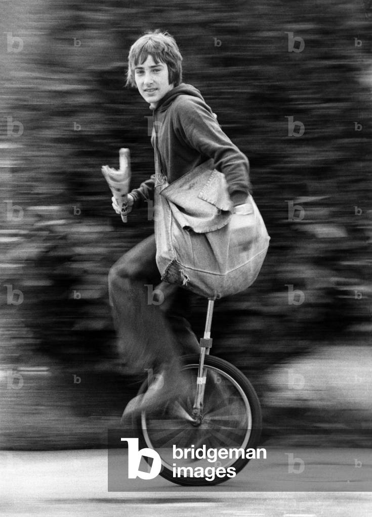 Newsboy Nigel Safe aged 14, knows what makes his paper round run smoothly- his unicycle. He can sort out the papers while he speeds around Cowplain, near Portsmouth, Hampshire. Nigel's dad, navy lieutenant Ron Safe. bought the unicycle in America. And over since the lad's been a big wheel in the business. June 1979