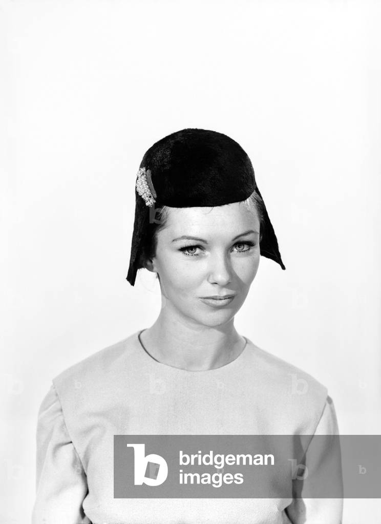 Model Uschi Bernell wearing wig hat, c. 1959 (b/w photo)