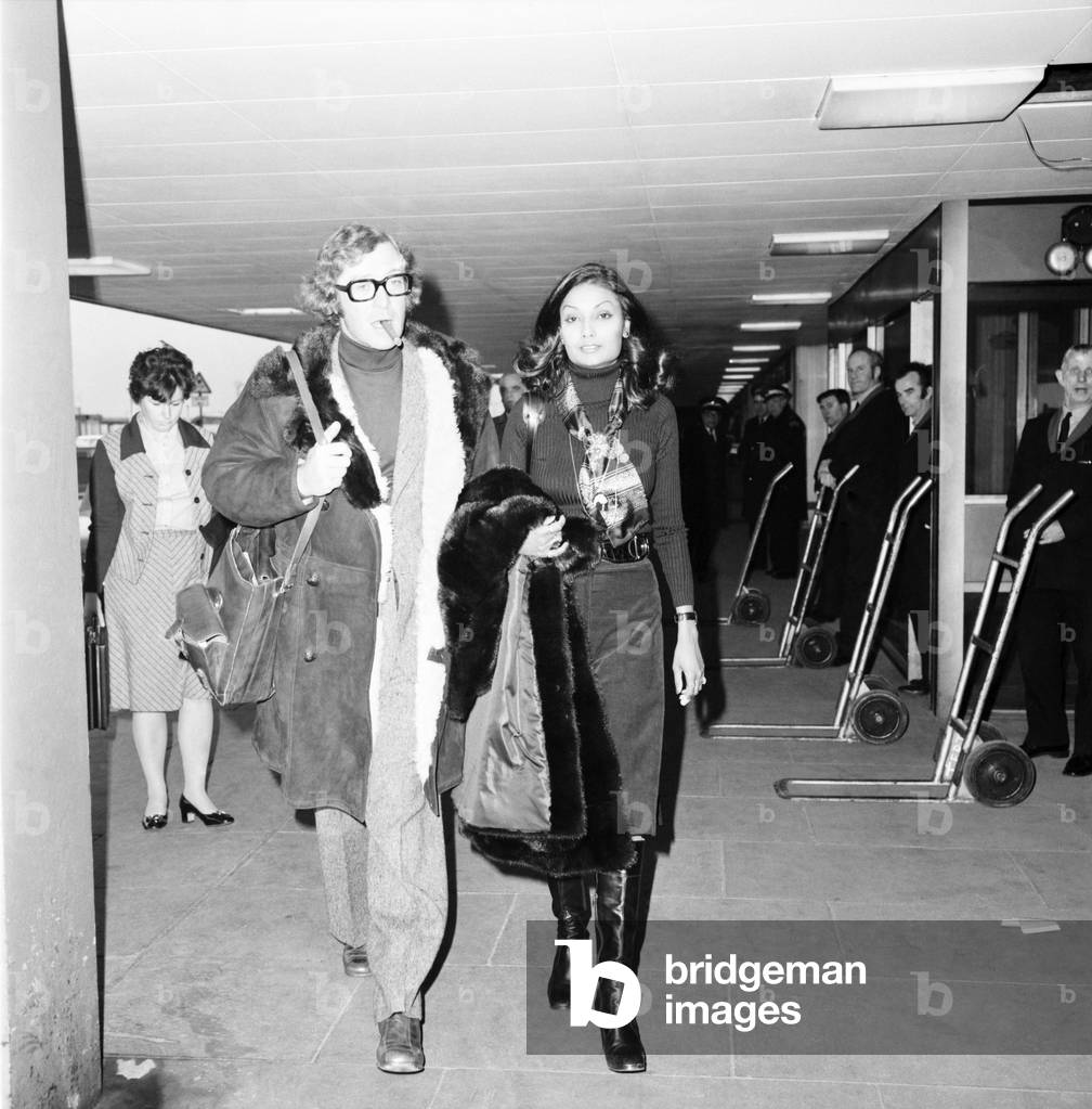 Actor Michael Caine and wife Shakira seen here at Heathrow Airport, April 1975 (b/w photo)