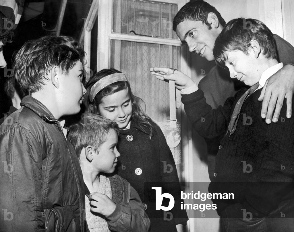 The Olympic silver medal swimmer Martyn Woodroffe, 18 years old, shows his silver medal to young local admirers who called at his home last night to offer congratulations, Cardiff, 29th October 1968 (b/w photo)