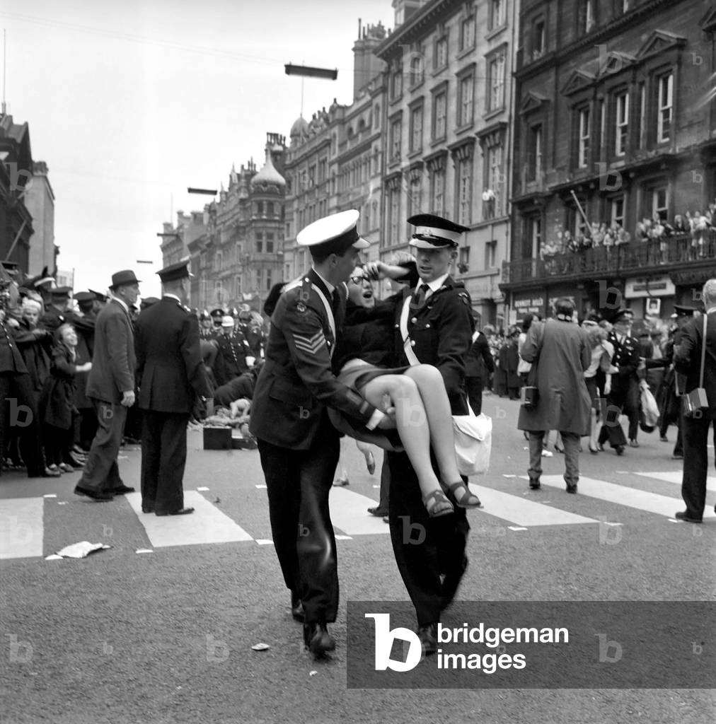 Northern premiere of The Beatles film A Hard Day's Night in Liverpool. 
Police help injured fans who were crushed while waiting for the group to arrive. 
July 1964