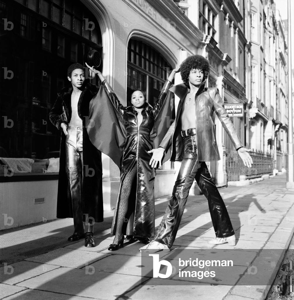 Black teenage boys and girls wearing fashion during a photo shoot.