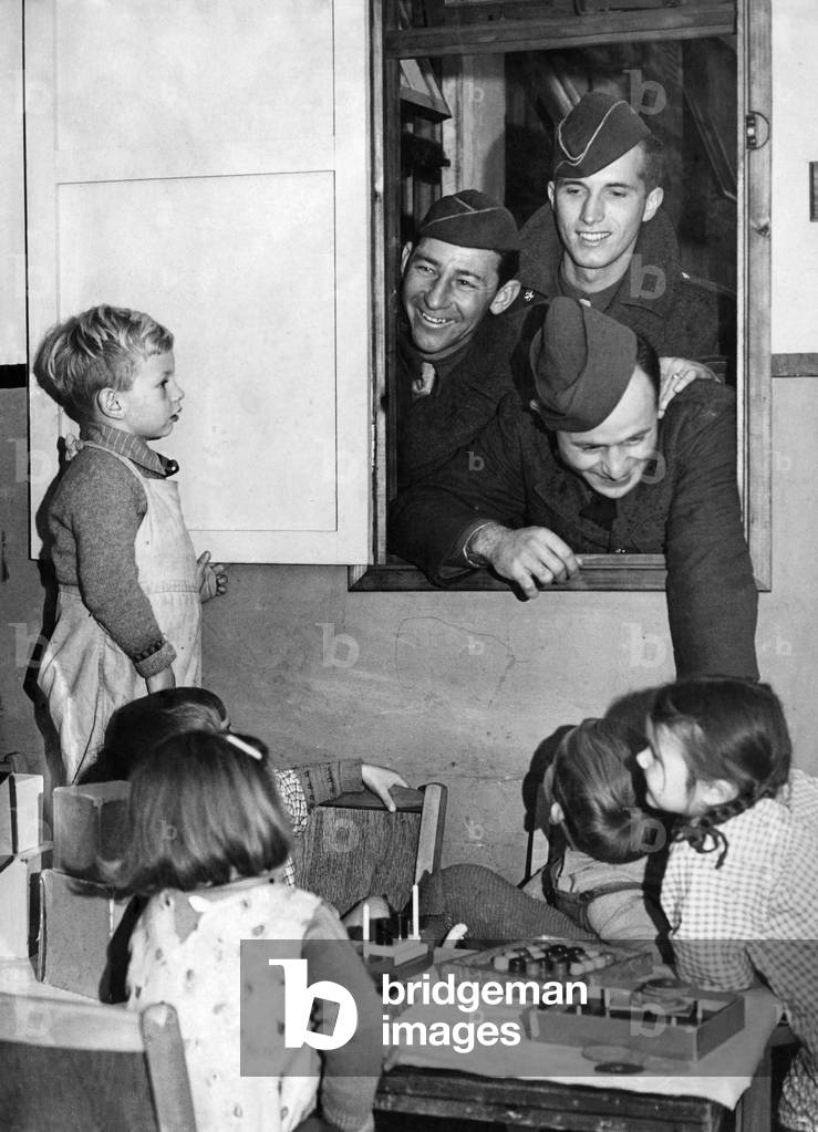 Soldiers with children in a nursery during World war two
November 1942