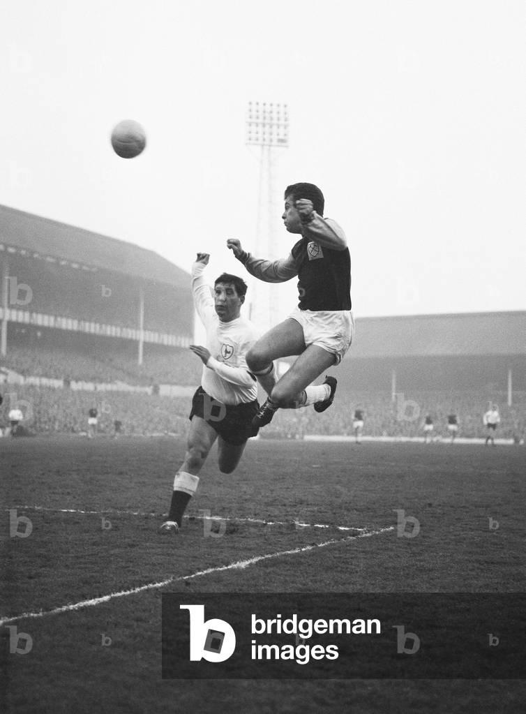 Division OneWest Ham 4 v. Tottenham Hotspur 4. Tony Scott of West Ham heads the ball over the cross bar beating Bobby Smith of Spurs. 27nd December 1962 (photo)