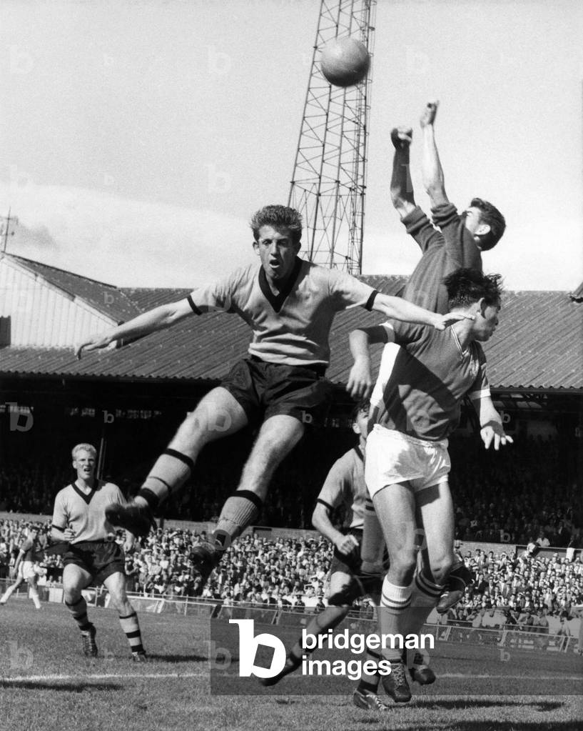 Peter Broadbent jumps high but cannot get his head to the ball as Bonetti the Chelsea goalkeeper leaps high to collect the ball. Bradbury is the other Chelsea player in the picture. August 1960 (photo)