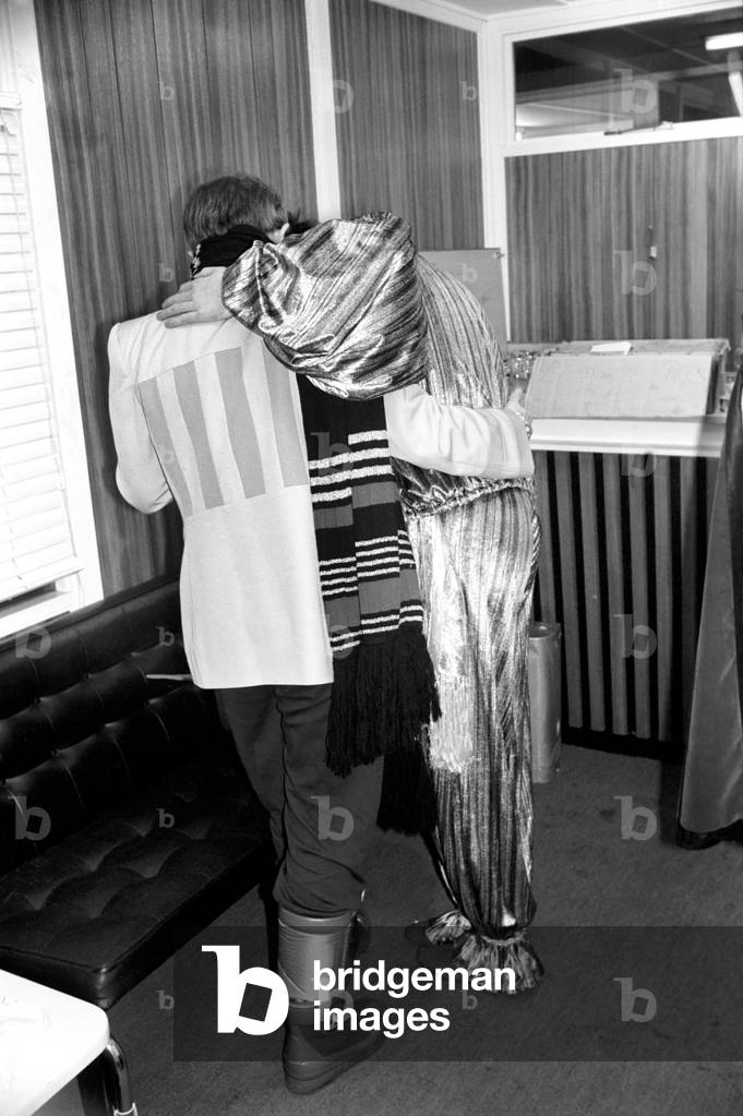 Rod Stewart and Elton John. Pop superstars Rod Stewart and Elton John make it up back stage at Olympic tonight just before Rod went on stage for the third night of his series of London concerts, December 1976 (b/w photo)
