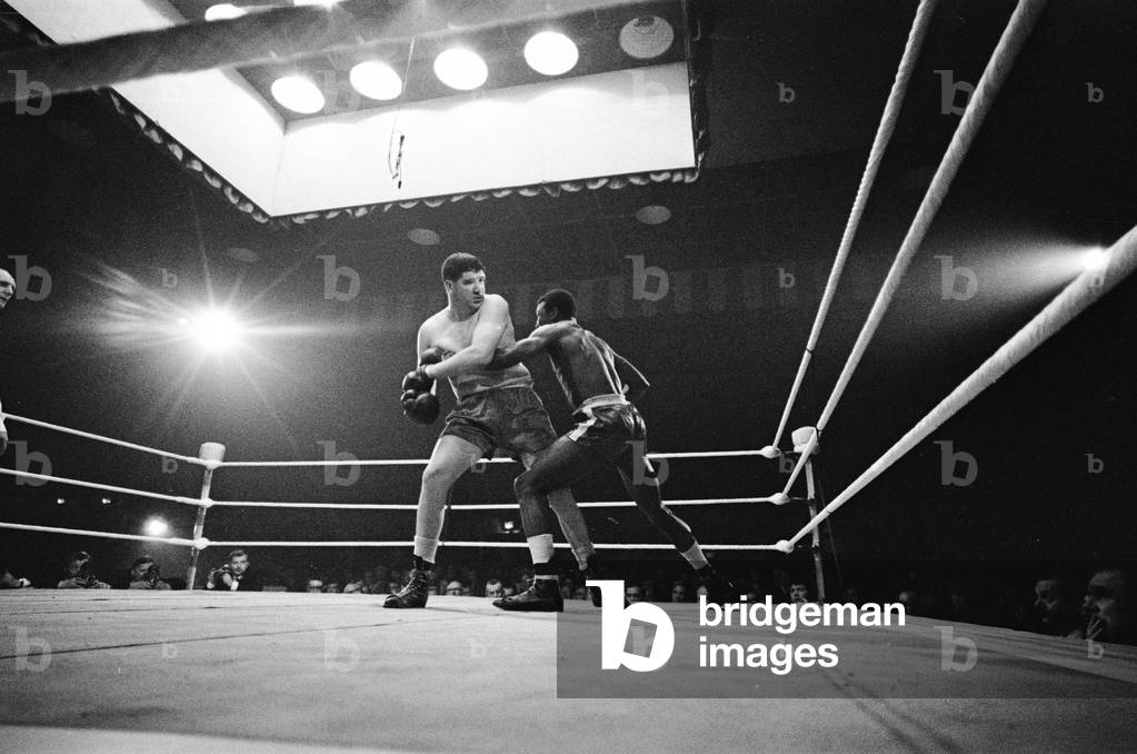 Heavyweight bout a The Stadium arena in Liverpool, Merseyside. Jim Mongahan in action against Lloyd Walford. Walford won the fight on points. 21st September 1965 (b/w photo)