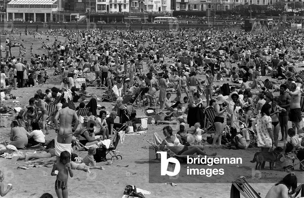 Holidaymakers on Margate beach during bank holiday, 27th May 1974 (b/w photo)