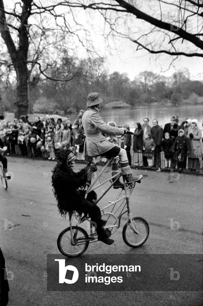 Gentleman in fancy dress seen here riding an unusual tandem bicycle in the Easter parade, Battersea Park, March 1975 (b/w photo)