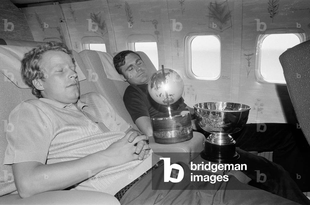 1970 London to Mexico World Cup Rally. The motor rally started at Wembley Stadium in London on 19 April 1970 and finished in Mexico City on 27 May 1970, covering approximately 16,000 miles. Pictured, exhausted winning drivers, Hannu Mikkola (light shirt) and Gunnar Palm, fly back to London from Mexico. 30th May 1970 (b/w photo)
