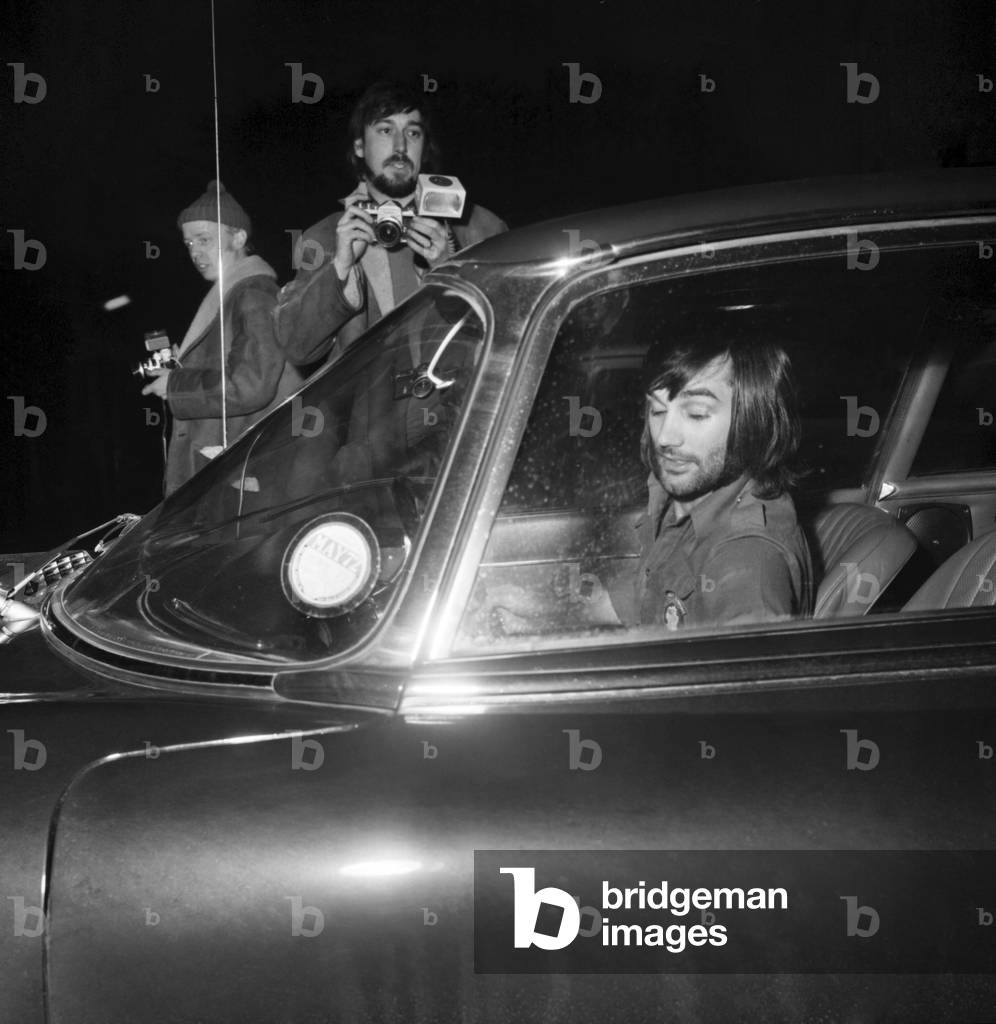 Photographers had been seeking George Best all day this one was still seeking as George when he arrived at Wilmslow station in his Jaguar to meet Carolyn Moore, January 1972 (b/w photo)