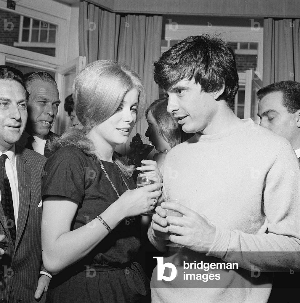 David Bailey and Catherine Deneuve have drinks with guests at a reception after their wedding, 18/08/1965 (b/w photo)