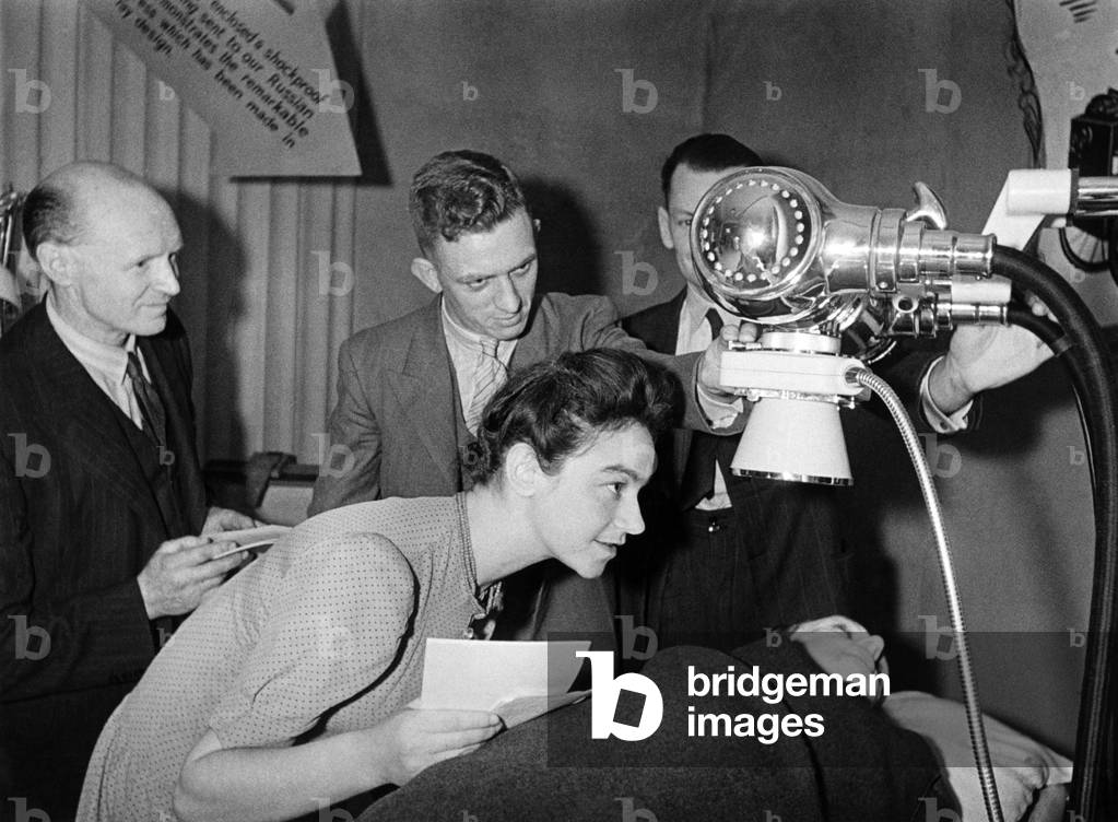 Workers from a Sunderland flying boat factory contributed £1500 towards X-Ray unit for Russia. They got the money by working half a day shift. Picture shows three of the workers from the factory showing a Russian girl Miss Tamara Eidnss their X-Ray unit at the 