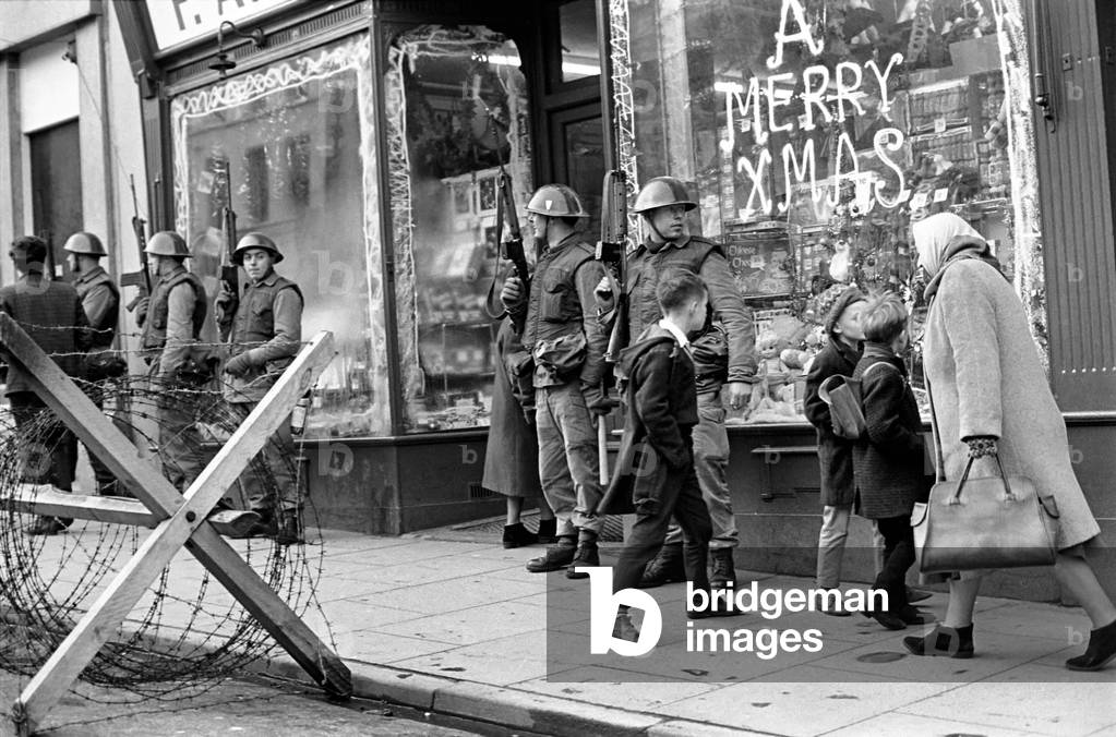 Armed soldiers on the streets of Londonderry, Northern Ireland during the Bernadette Devlin court case. 
December 1969