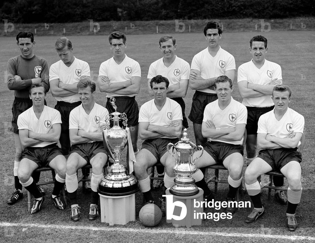 The Double winning Tottenham Hotspur football team pose with the League Championship and FA Cup trophies at their training ground. Back row L-R: Bill Brown, Ron Henry, Peter Baker, Danny Blanchflower, Maurice Norman, Dave Mackay, Front Row L-R: Cliff Jones, John White, Bobby Smith, Les Allen, and Terry Dyson August 1961 (photo)