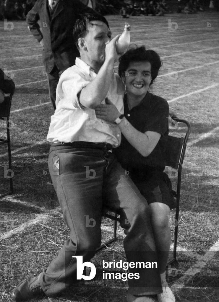 Wounded soldier in and feed the Baby race at Horton Emergency Hospital (Epson) - in this race the man has to run 100 yards then drink milk from bottle held by nurse. July 1943