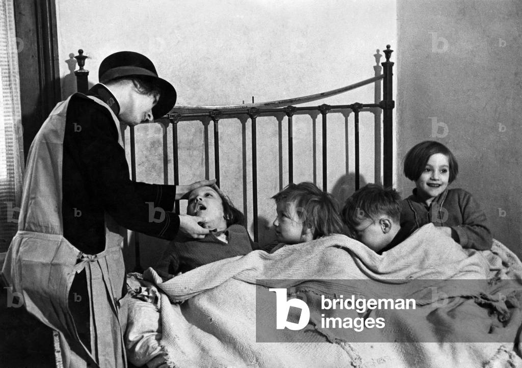 Children tucked up in bed at a Salvation Army place.