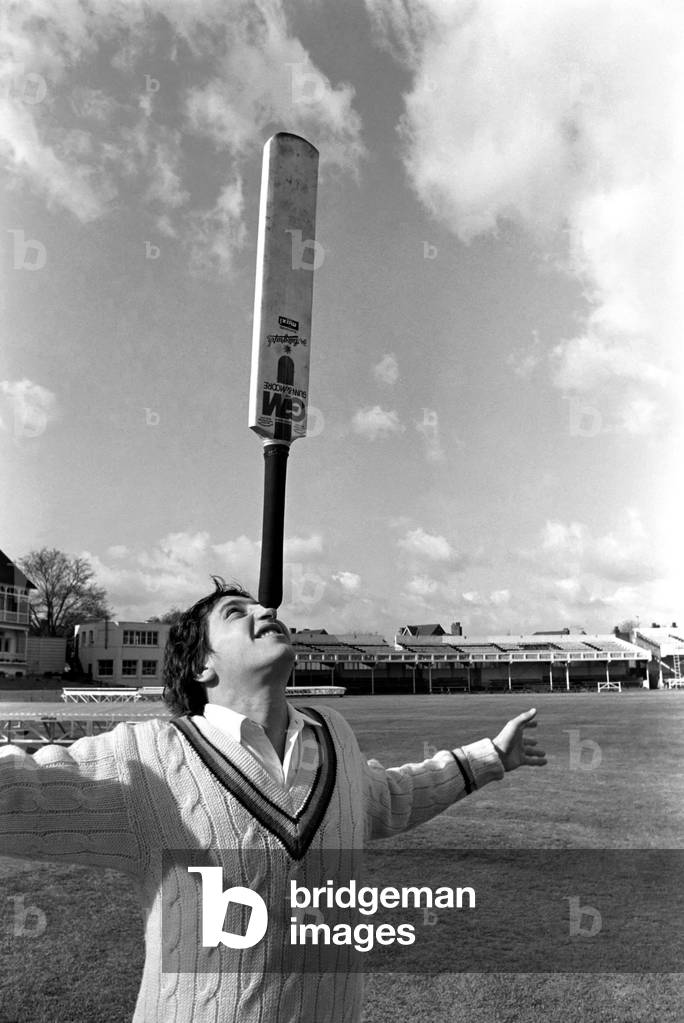 Cricketer Derek Randall and his repertoire of tricks photographed at Trent Bridge as he prepares for the new season. Balancing and juggling the cricket bat, April 1977 (b/w photo)